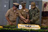 NORFOLK, Va. (Sept. 20, 2022) Wasp-class amphibious assault ship USS Bataan (LHD 5) Commanding Officer Capt. Joseph Murphy III (Middle), Religious Programs Specialist Seaman Apprentice Erick Washington (Right) and Senior Chief Logistics Specialist Archie Pahati participate in a ceremonial cake cutting during Bataan’s 25th birthday celebration, Sept. 20, 2022. Bataan is homeported at Naval Station Norfolk. (U.S. Navy photo by Mass Communications Specialist 2nd Class Darren Newell)