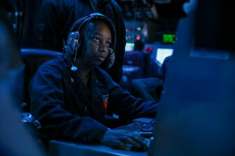 TAIWAN STRAIT (Sept. 20, 2022) Operations Specialist 2nd Class Quiana Jordan, from East Orange, New Jersey, stands tactical information coordinator watch in the combat information center of the guided-missile destroyer USS Higgins (DDG 76) transits through the Taiwan Strait.