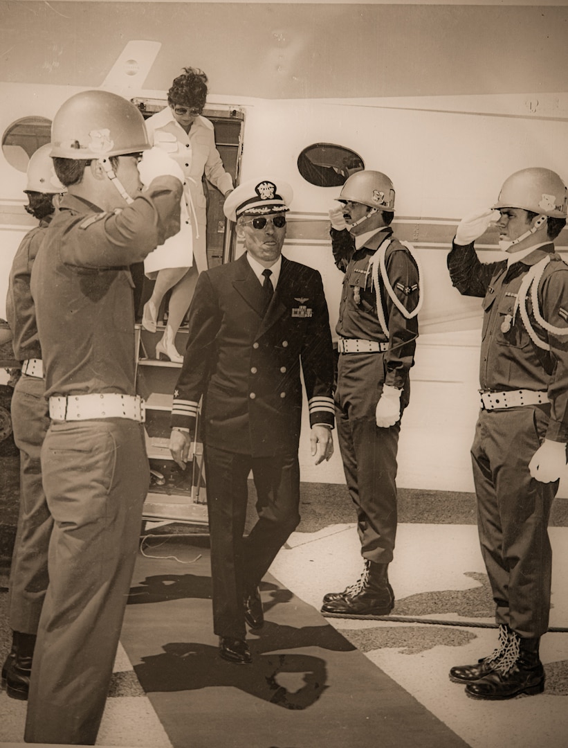 Male walks between male soldiers