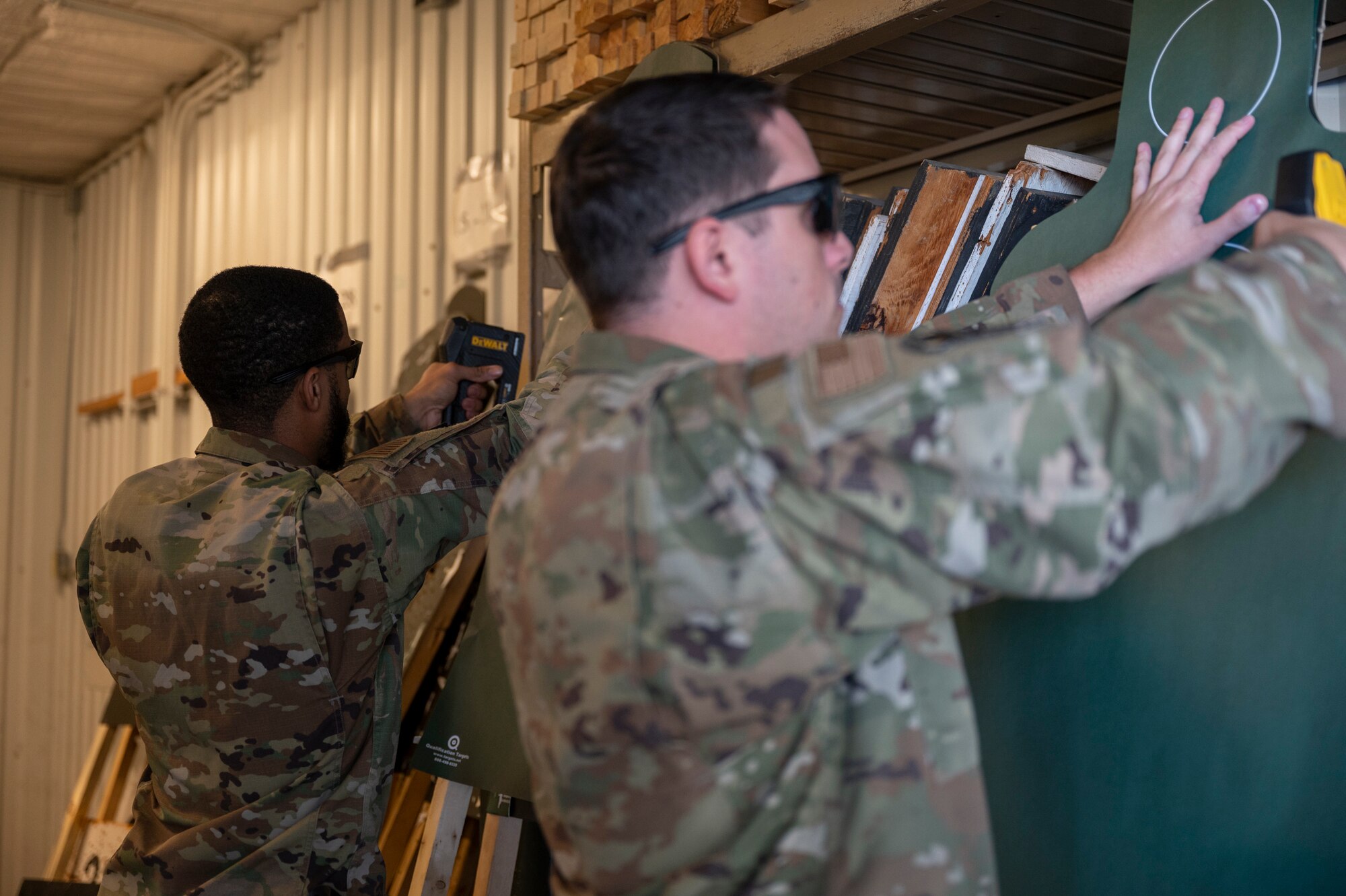 Picture of two men setting up target boards.