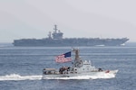 Coast Guard Cutter Adak of PATFORSWA provides escort for aircraft carrier USS Nimitz through the Strait of Hormuz. (U.S. Coast Guard)