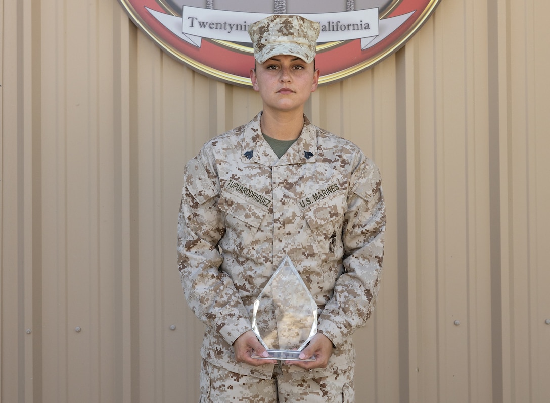 U.S. Marine Corps Sgt. Leilana TupuaRodriguez, a criminal investigator with Criminal Investigation Division, Provost Marshal’s Office, Marine Corps Air Ground Combat Center (MCAGCC) poses for a photo with the Jim Kallstrom Award for bravery presented at the Combat Center, Twentynine Palms, California, Aug. 29, 2022. TupuaRodriguez, a native of Bremerton, Washington, received the award for her bravery while deployed with the 24th Marine Expeditionary Unit, supporting evacuations during the bombing in Kabul that took the life of 13 service members in August of 2021.