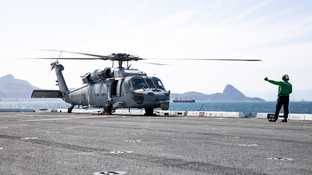 U.S. Navy Aviation Electrician’s Mate 3rd Class John Duncan directs an MH-60S SeaHawk, assigned to Helicopter Sea Combat Squadron (HSC) 22, conducting pre-flight checks on the flight deck of the amphibious transport dock ship USS Mesa Verde (LPD 19) in support of Special Purpose Marine Air-Ground Task Force UNITAS LXIII, Sept. 6, 2022. The helicopters were being launched to ferry U.S. Marines and their equipment ashore during exercise UNITAS LXIII. UNITAS is the world’s longest-running annual multinational maritime exercise that focuses on enhancing interoperability among multiple nations and joint forces during littoral and amphibious operations in order to build on existing regional partnerships and create new enduring relationships that promote peace, stability and prosperity in the U.S. Southern Command’s area of responsibility. (U.S. Marine Corps photo by Sgt. Brendan Mullin)