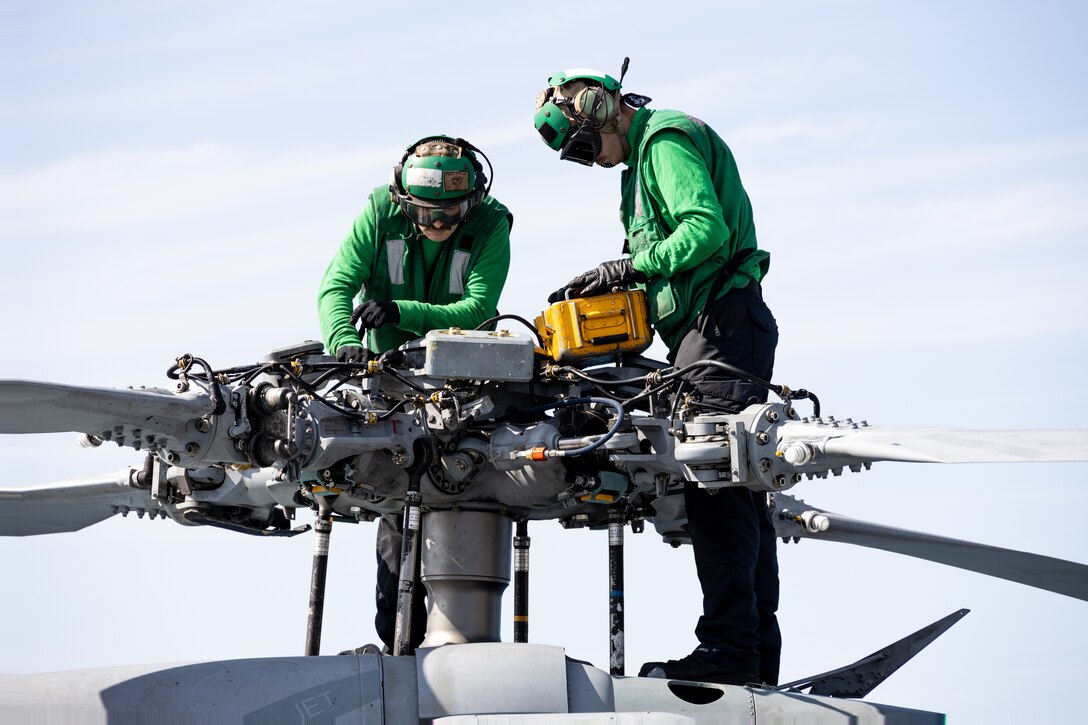 U.S. Navy Aviation Electrician’s Mate Seaman Brian Hernandez, left, and Aviation Electrician’s Mate Seaman Daniel Rogers, conduct pre-flight checks of an MH-60S SeaHawk, assigned to Helicopter Sea Combat Squadron (HSC) 22, on the flight deck of the amphibious transport dock ship USS Mesa Verde (LPD 19) in support of Special Purpose Marine Air-Ground Task Force UNITAS LXIII, Sept. 6, 2022. The helicopters were being launched to ferry U.S. Marines and their equipment ashore during exercise UNITAS LXIII. UNITAS is the world’s longest-running annual multinational maritime exercise that focuses on enhancing interoperability among multiple nations and joint forces during littoral and amphibious operations in order to build on existing regional partnerships and create new enduring relationships that promote peace, stability and prosperity in the U.S. Southern Command’s area of responsibility. (U.S. Marine Corps photo by Sgt. Brendan Mullin)