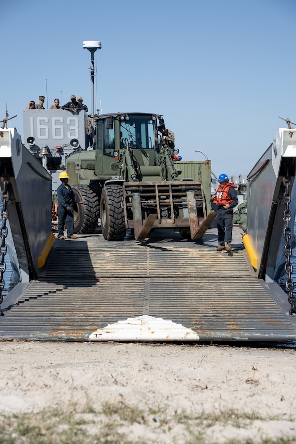 U.S. Sailors prepare to unload U.S. Marines and their equipment from U.S. Navy Landing Craft, Utility 1663 after beaching in Rio de Janeiro in support of Special Purpose Marine Air-Ground Task Force UNITAS LXIII, Sept. 2, 2022. Marines and their equipment are moving ashore from the amphibious transport dock ship USS Mesa Verde (LPD 19) to begin training during Exercise UNITAS LXIII.  UNITAS is the world’s longest-running annual multinational maritime exercise that focuses on enhancing interoperability among multiple nations and joint forces during littoral and amphibious operations in order to build on existing regional partnerships and create new enduring relationships that promote peace, stability and prosperity in the U.S. Southern Command’s area of responsibility. (U.S. Marine Corps photo by Sgt. Brendan Mullin)