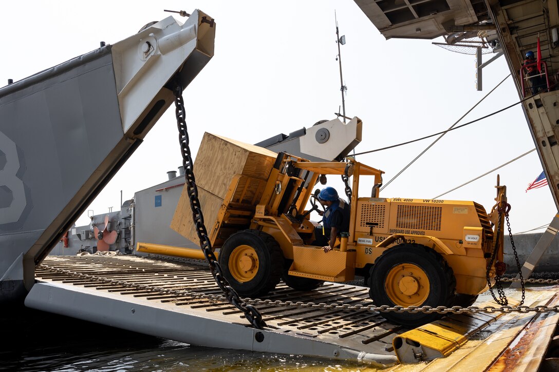 A U.S. Navy forklift moves U.S. Marine Corps equipment aboard Landing Craft, Utility 1663 from the amphibious transport dock ship USS Mesa Verde (LPD 19) in Rio de Janeiro  in support of Special Purpose Marine Air-Ground Task Force UNITAS LXIII, Sept. 3, 2022. Marines and their equipment are moving ashore from the Mesa Verde to begin training during UNITAS LXIII.  UNITAS is the world’s longest-running annual multinational maritime exercise that focuses on enhancing interoperability among multiple nations and joint forces during littoral and amphibious operations in order to build on existing regional partnerships and create new enduring relationships that promote peace, stability and prosperity in the U.S. Southern Command’s area of responsibility. (U.S. Marine Corps photo by Sgt. Brendan Mullin)