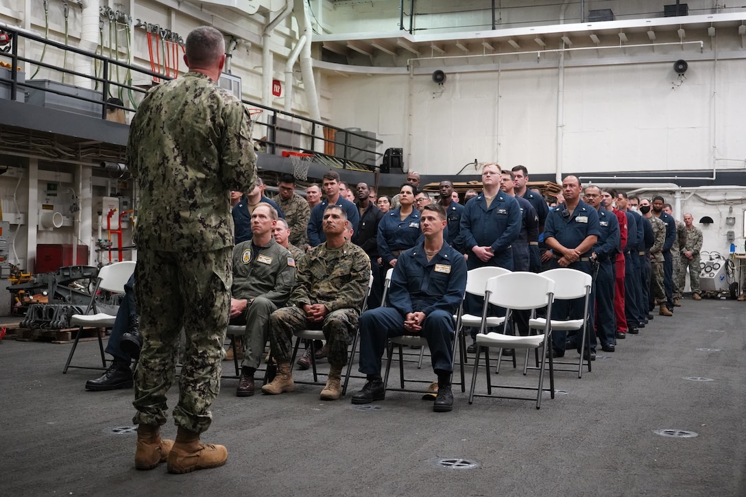 Rear Adm. Jim Aiken, commander of U.S. Naval Southern Forces Command/U.S. 4th Fleet, addresses a formation of Marines and Sailors aboard the USS Mesa Verde (LPD 19) during a 9/11 remembrance ceremony while afloat during exercise UNITAS LXIII off the coast of Brazil, Sept. 11, 2022. The ceremony recognized those who were lost on Sept. 11, 2001, and afforded the service members time to reflect on their service and patriotism. UNITAS is the world’s longest-running annual multinational maritime exercise that focuses on enhancing interoperability among multiple nations and joint forces during littoral and amphibious operations in order to build on existing regional partnerships and create new enduring relationships that promote peace, stability, and prosperity in the U.S. Southern Command’s area of responsibility. (U.S. Marine Corps photo by Maj. Jeremy Wheeler)