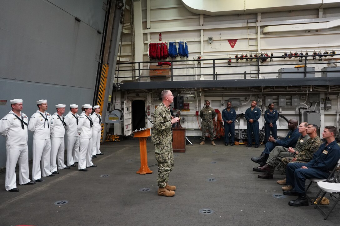 Rear Adm. Jim Aiken, commander of U.S. Naval Southern Forces Command/U.S. 4th Fleet, addresses a formation of Marines and Sailors aboard the USS Mesa Verde (LPD 19) during a 9/11 remembrance ceremony while afloat during exercise UNITAS LXIII off the coast of Brazil, Sept. 11, 2022. Rear Adm. Aiken discussed the resiliency of the American fighting spirit and the dedication of service members to their fellow service members, partners, and allies. The remembrance ceremony occurred amongst the 63rd iteration of exercise UNITAS. UNITAS is the world’s longest-running annual multinational maritime exercise that focuses on enhancing interoperability among multiple nations and joint forces during littoral and amphibious operations in order to build on existing regional partnerships and create new enduring relationships that promote peace, stability, and prosperity in the U.S. Southern Command’s area of responsibility. (U.S. Marine Corps photo by Maj. Jeremy Wheeler)