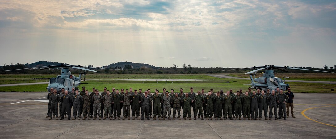 U.S. Marines with Marine Light Attack Helicopter Squadron (HMLA) 773, 4th Marine Aircraft Wing, Marine Forces Reserve in support of Special Purpose Marine Air-Ground Task Force UNITAS LXIII, pose for a photo at São Pedro da Aldeia, Brazil, Sept. 13, 2022. UNITAS is the world's longest-running annual multinational maritime exercise that focuses on enhancing interoperability among multiple nations and joint forces during littoral and amphibious operations in order to build on existing regional partnerships and create new enduring relationships that promote peace, stability, and prosperity in the U.S. Southern Command’s area of responsibility.  (U.S. Marine Corps photo by Cpl. Colton K. Garrett)