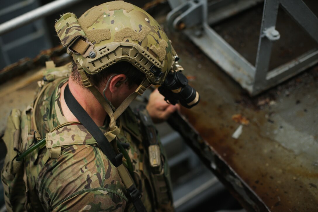 A U.S. Sailor assigned to a Navy SEAL Team, climbs down a hatch during Visit, Board, Search, and Seizure (VBSS) training during exercise UNITAS LXIII in Rio de Janeiro, Sept. 15, 2022. UNITAS is the world’s longest-running annual multinational maritime exercise that focuses on enhancing interoperability among multiple nations and joint forces during littoral and amphibious operations in order to build on existing regional partnerships and create new enduring relationships that promote peace, stability, and prosperity in the U.S. Southern Command’s area of responsibility. (U.S. Marine Corps photo by Cpl. Ethan Craw)