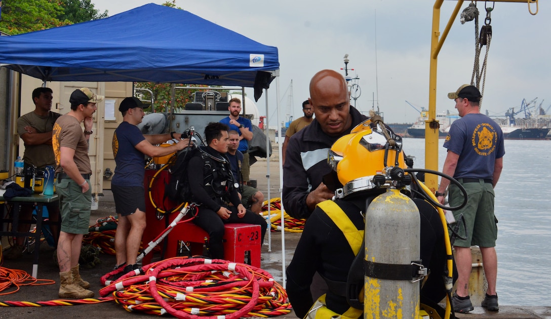 RIO DE JANEIRO – U.S. Navy divers, assigned to Mobile Diving and Salvage Unit 2 (MDSU-2) and their Brazilian counterparts get ready for a dive during UNITAS LXIII, Sept. 14, 2022. UNITAS is the world’s longest-running maritime exercise. Hosted this year by Brazil, it brings together multinational forces from Belize, Brazil, Cameroon, Chile, Colombia, Dominican Republic, Ecuador, France, Guyana, Jamaica, Mexico, Namibia, Panama, Paraguay, Peru, South Korea, Spain, United Kingdom, Uruguay, and the United States conducting operations in and off the coast of Rio de Janeiro. The exercise trains forces to conduct joint maritime operations through the execution of anti-surface, anti-submarine, anti-air, amphibious and electronic warfare operations that enhance warfighting proficiency and increase interoperability among participating naval and marine forces. (U.S. Navy photo by Mass Communication Specialist 3rd Class Jahlena Royer/Released)