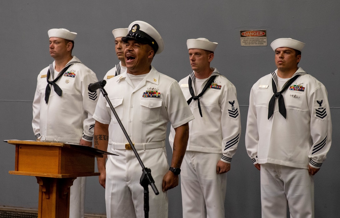 ATLANTIC OCEAN (Sept. 11, 2022) – Culinary Specialist Senior Chief Maurice Gaskin sings the national anthem during a 9/11 memorial ceremony in the hangar bay of the amphibious transport dock ship USS Mesa Verde (LPD 19), Sept. 11, 2022. Mesa Verde is currently underway in the Atlantic Ocean in support of exercise UNITAS LXIII. UNITAS is the world’s longest-running maritime exercise. Hosted this year by Brazil, it brings together multinational forces from Belize, Brazil, Cameroon, Chile, Colombia, Dominican Republic, Ecuador, France, Guyana, Jamaica, Mexico, Namibia, Panama, Paraguay, Peru, South Korea, Spain, United Kingdom, Uruguay, and the United States conducting operations in and off the coast of Rio de Janeiro. The exercise trains forces to conduct joint maritime operations through the execution of anti-surface, anti-submarine, anti-air, amphibious and electronic warfare operations that enhance warfighting proficiency and increase interoperability among participating naval and marine forces. (U.S. Navy photo by Mass Communication Specialist 3rd Class Sydney Milligan)
