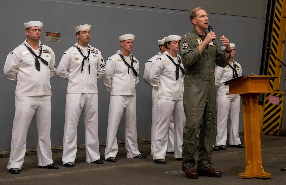 ATLANTIC OCEAN (Sept. 11, 2022) – U.S. Navy Captain Michael Nordeen, commanding officer of the amphibious transport dock ship USS Mesa Verde (LPD 19), speaks during a 9/11 memorial ceremony in the hangar bay, Sept. 11, 2022. Mesa Verde is currently underway in the Atlantic Ocean in support of exercise UNITAS LXIII. UNITAS is the world’s longest-running maritime exercise. Hosted this year by Brazil, it brings together multinational forces from Belize, Brazil, Cameroon, Chile, Colombia, Dominican Republic, Ecuador, France, Guyana, Jamaica, Mexico, Namibia, Panama, Paraguay, Peru, South Korea, Spain, United Kingdom, Uruguay, and the United States conducting operations in and off the coast of Rio de Janeiro. The exercise trains forces to conduct joint maritime operations through the execution of anti-surface, anti-submarine, anti-air, amphibious and electronic warfare operations that enhance warfighting proficiency and increase interoperability among participating naval and marine forces. (U.S. Navy photo by Mass Communication Specialist 3rd Class Sydney Milligan)