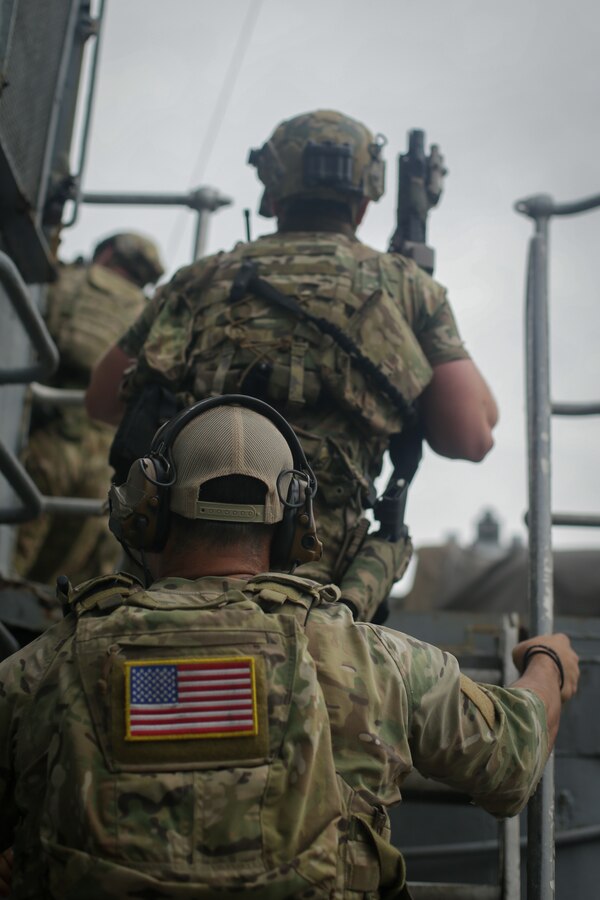 U.S. Sailors assigned to a Navy SEAL Team, make their way toward a command deck during Visit, Board, Search, and Seizure (VBSS) training with partner nations during exercise UNITAS LXIII in Rio de Janeiro, Sept. 15, 2022. UNITAS is the world’s longest-running annual multinational maritime exercise that focuses on enhancing interoperability among multiple nations and joint forces during littoral and amphibious operations in order to build on existing regional partnerships and create new enduring relationships that promote peace, stability, and prosperity in the U.S. Southern Command’s area of responsibility. (U.S. Marine Corps photo by Cpl. Ethan Craw)