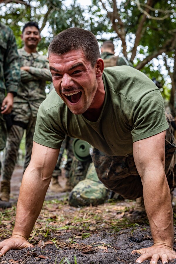 U.S. Marine Corps Cpl. Joshua Grant, a squad leader with Lima Company, 3rd Battalion, 25th Marine Regiment, 4th Marine Division, in support of Special Purpose Marine Air-Ground Task Force UNITAS LXIII participates in a push-up competition during exercise UNITAS LXIII in Marambaia, Brazil, Sept. 11, 2022. The competition included marines from multiple partner nations and built camaraderie between forces. UNITAS trains forces to conduct joint maritime operations through the execution of anti-surface, anti-submarine, anti-air, amphibious, and electronic warfare operations that enhance warfighting proficiency and increase interoperability among participating navy and marine forces. Grant is a native of Chillicothe, Ohio. (U.S. Marine Corps photo by Lance Cpl. David Intriago)