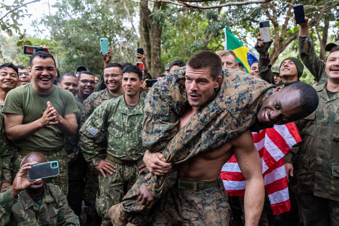 U.S. Marine Corps Cpl. Joshua Grant, a squad leader with Lima Company, 3rd Battalion, 25th Marine Regiment, 4th Marine Division in support of Special Purpose Marine Air-Ground Task Force UNITAS LXIII participates in a buddy squat competition during exercise UNITAS LXIII in Marambaia, Brazil, Sept. 11, 2022. The competition included marines from multiple partner nations and built camaraderie between forces. UNITAS develops and sustains relationships that improve the capacity of our reemerging and enduring maritime partners to achieve common objectives. Additionally, the military-to-military exchanges foster friendly, mutual cooperation and understanding among participating navies and marine corps. Grant is a native of Chillicothe, Ohio. (U.S. Marine Corps photo by Lance Cpl. David Intriago)