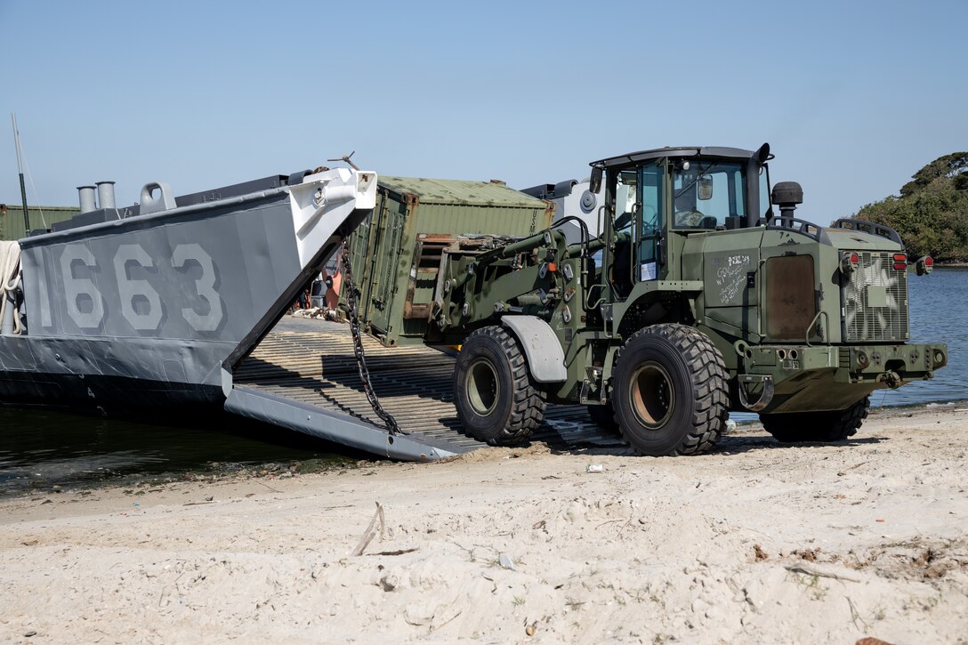 A U.S. Marine Corps forklift moves storage containers ashore from Landing Craft, Utility 1663 in Rio de Janeiro in support of Special Purpose Marine Air-Ground Task Force UNITAS LXIII, Sept. 2, 2022. Marines and their equipment moved ashore from the amphibious transport dock ship USS Mesa Verde (LPD -19) to begin training during UNITAS LXIII.  UNITAS is the world’s longest-running annual multinational maritime exercise that focuses on enhancing interoperability among multiple nations and joint forces during littoral and amphibious operations in order to build on existing regional partnerships and create new enduring relationships that promote peace, stability and prosperity in the U.S. Southern Command’s area of responsibility. (U.S. Marine Corps photo by Sgt. Brendan Mullin)