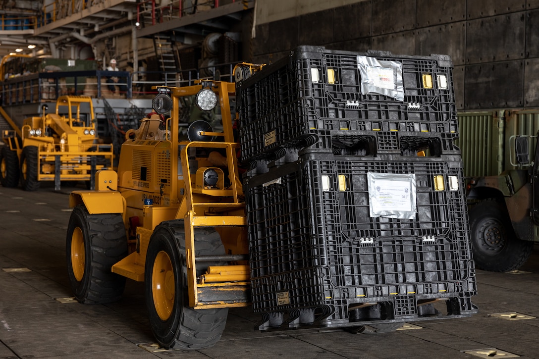 A U.S. Navy forklift moves U.S. Marine Corps equipment through the well deck of the amphibious transport dock ship USS Mesa Verde (LPD 19) in Rio de Janeiro in support of Special Purpose Marine Air-Ground Task Force UNITAS LXIII, Sept. 3, 2022. Marines and their equipment are moving ashore from the Mesa Verde to begin training during UNITAS LXIII.  UNITAS is the world’s longest-running annual multinational maritime exercise that focuses on enhancing interoperability among multiple nations and joint forces during littoral and amphibious operations in order to build on existing regional partnerships and create new enduring relationships that promote peace, stability and prosperity in the U.S. Southern Command’s area of responsibility. (U.S. Marine Corps photo by Sgt. Brendan Mullin)