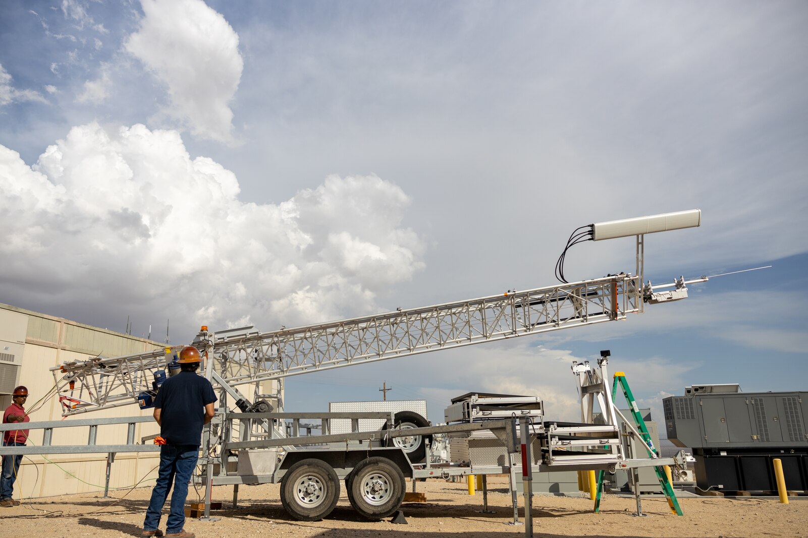 U.S. Marine Corps government employees raise a 5G tower in preparation for a 5G network demonstration at MCAGCC