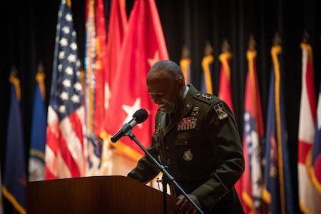 man wearing u.s. army uniform standing on a stage.