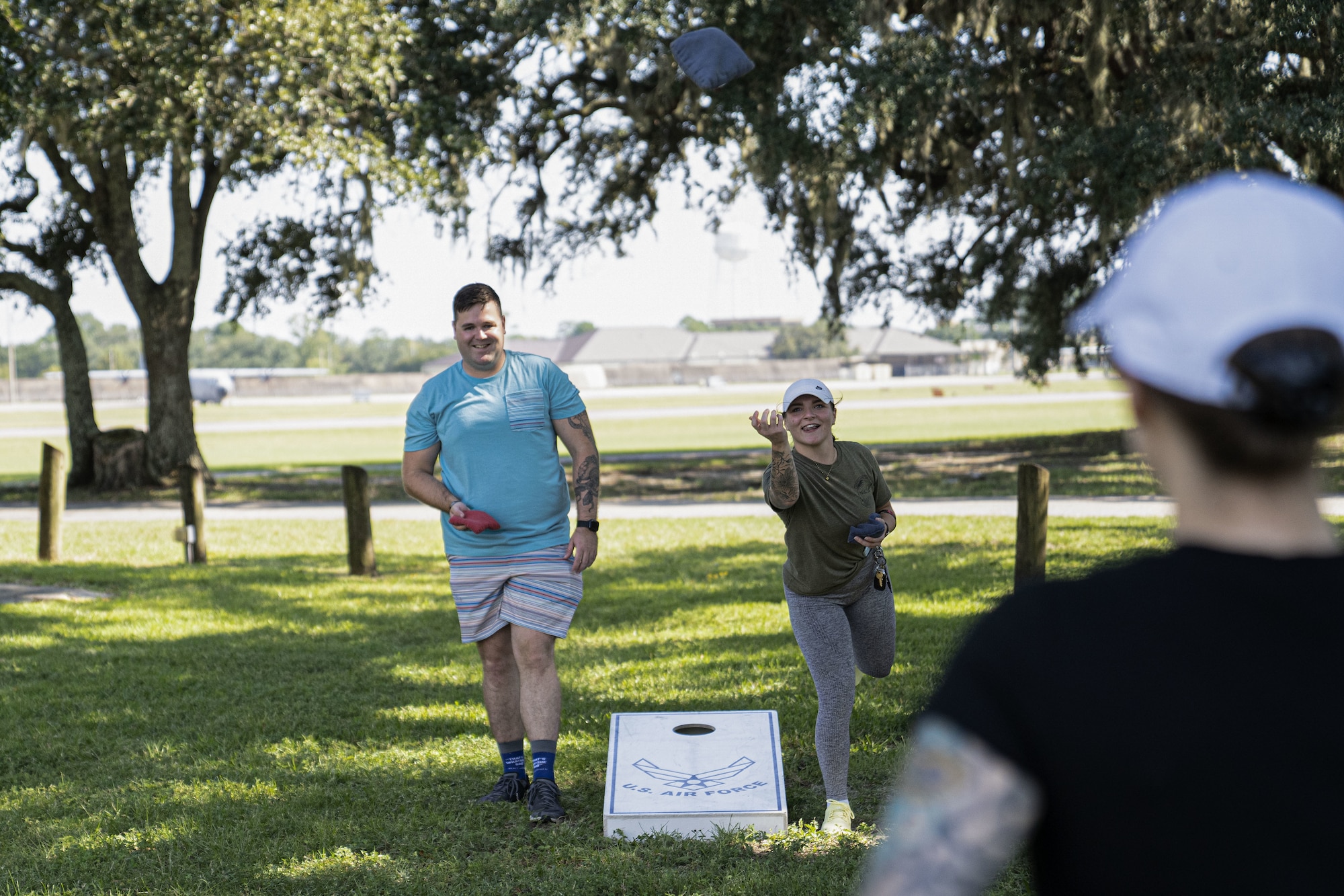 U.S. Air Force Senior Airmen Willie Brock and Karlynna Quitugua, 81st Security Force Squadron patrolmen, play cornhole during the squadron’s morale day at the marina on Keesler Air Force Base, Mississippi, Sept. 16, 2022. The squadron used Unite Funds to celebrate their first morale day since the start of COVID-19.