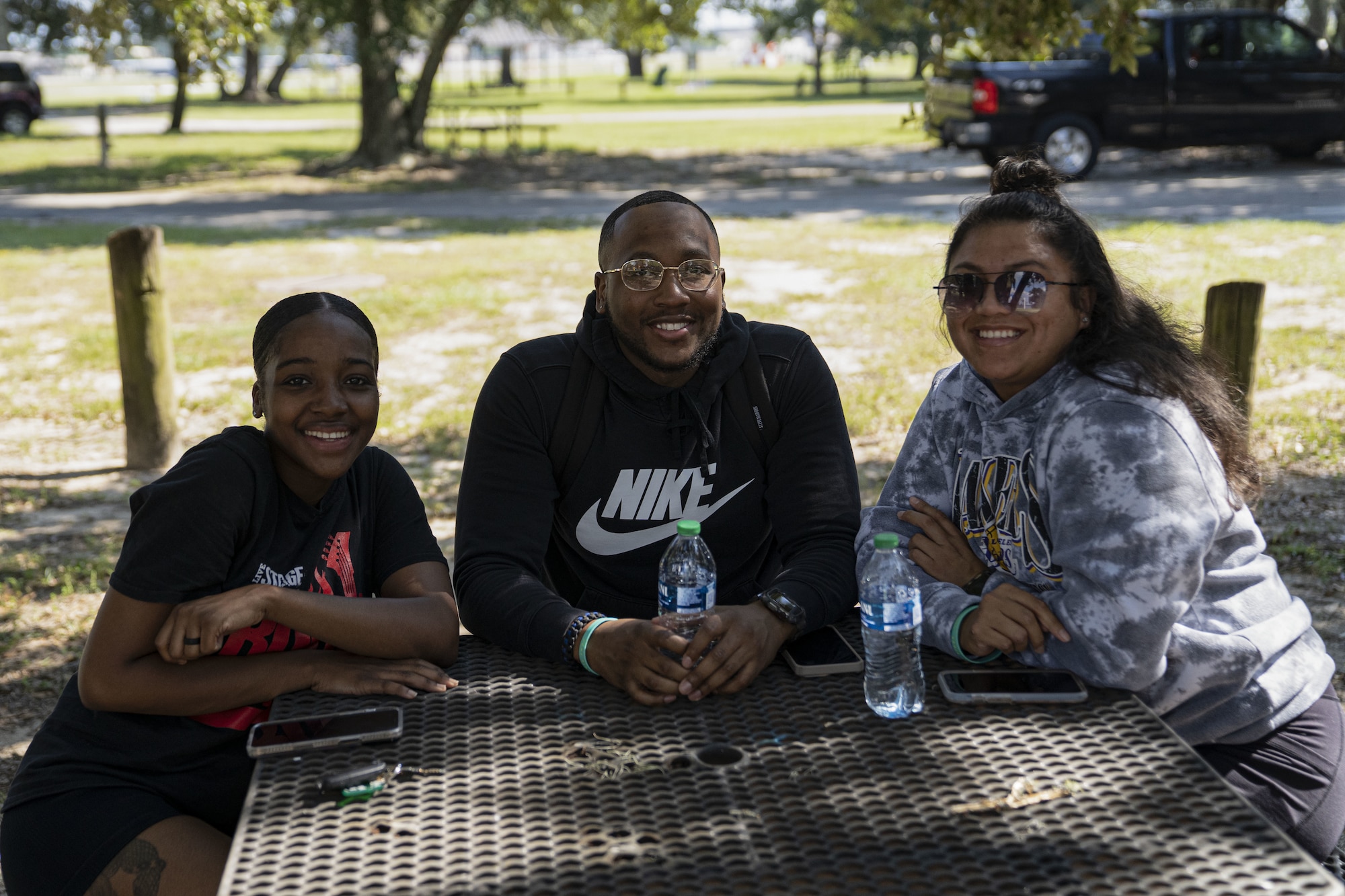 U.S. Air Force Senior Airman Shamari Carter, 81st Security Forces Squadron reports and analysis technician, and Senior Airmen Willie Brock and Karlynna Quitugua, 81st SFS patrolmen, pose for photo at the squadron’s morale day at the marina on Keesler Air Force Base, Mississippi, Sept. 16, 2022. The squadron used Unite Funds to celebrate their first morale day since the start of COVID-19.