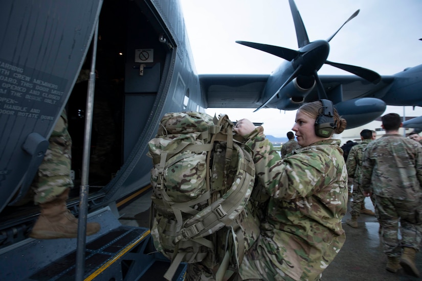 Soldiers of the Alaska Army National Guard transfer their luggage prior to boarding a HC-130 Combat King II for transport to Bethel, Alaska, Sept. 21, 2022. Approximately 100 members of the Alaska Organized Militia, which is comprised of the Alaska National Guard, Alaska State Defense Force and Alaska Naval Militia, were activated following a disaster declaration issued Sept. 17 after the remnants of Typhoon Merbok caused dramatic flooding across more than 1,000 miles of Alaskan coastline. (Alaska National Guard photo by Victoria Granado)