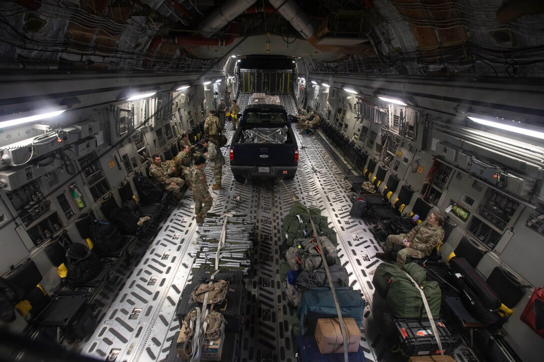 Soldiers of the Alaska Army National Guard board a C-17 Globemaster III for transport to Eielson Air Force Base to pick up additional service members, Sept. 21, 2022. Approximately 100 members of the Alaska Organized Militia, which is comprised of the Alaska National Guard, Alaska State Defense Force and Alaska Naval Militia, were activated following a disaster declaration issued Sept. 17 after the remnants of Typhoon Merbok caused dramatic flooding across more than 1,000 miles of Alaskan coastline. (Alaska National Guard photo by Victoria Granado)