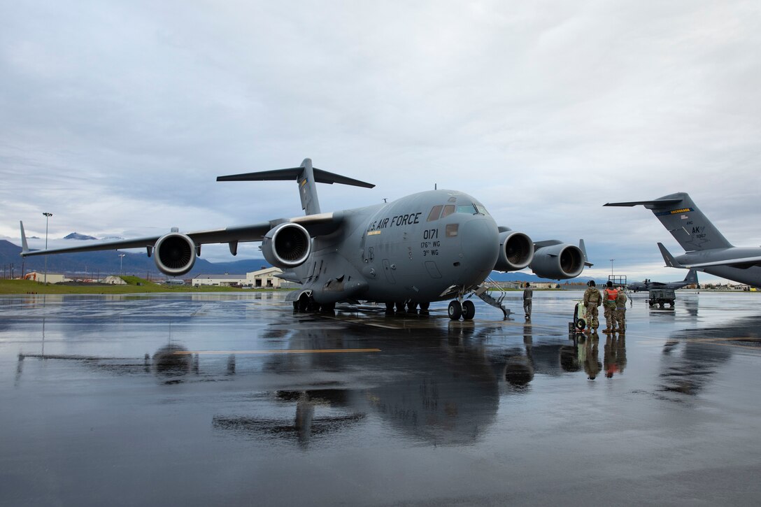 Service members of Alaska Air National Guard's 176th Wing conduct an engine check on a C-17 Globemaster II prior to take off for Eielson Air Force Base, Sept. 21, 2022. Approximately 100 members of the Alaska Organized Militia, which is comprised of the Alaska National Guard, Alaska State Defense Force and Alaska Naval Militia, were activated following a disaster declaration issued Sept. 17 after the remnants of Typhoon Merbok caused dramatic flooding across more than 1,000 miles of Alaskan coastline. (Alaska National Guard photo by Victoria Granado)