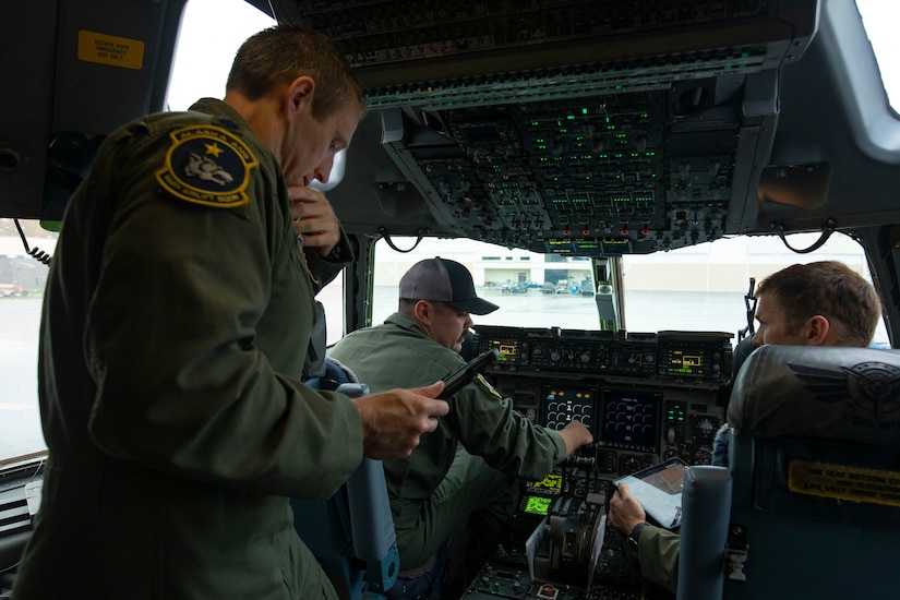 Flight crew of Alaska Air National Guard's 144th Airlift Squadron conduct pre-flight checks on a C-17 Globemaster II prior to take off for Eielson Air Force Base, Sept. 21, 2022. Approximately 100 members of the Alaska Organized Militia, which is comprised of the Alaska National Guard, Alaska State Defense Force and Alaska Naval Militia, were activated following a disaster declaration issued Sept. 17 after the remnants of Typhoon Merbok caused dramatic flooding across more than 1,000 miles of Alaskan coastline. (Alaska National Guard photo by Victoria Granado)