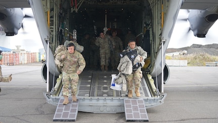Alaska Army National Spc. Mark Ibay, a petroleum supply specialist with E Company, 1st Battalion, 207th Aviation, left, and Sgt. Maj. Arturo Bautista, operations sergeant major with 38th Troop Command and noncommissioned officer in charge of Joint Task Force – Bethel, exit an HC-130J Combat King II aircraft from the 176th Wing’s 211th Rescue Squadron after arriving in Bethel for disaster relief response Sept. 21, 2022. Approximately 100 service members from the Alaska National Guard, Alaska State Defense Force and Alaska Naval Militia were activated following a disaster declaration issued Sept. 17 after the remnants of Typhoon Merbok caused dramatic flooding across more than 1,000 miles of Alaskan coastline. A JTF in Nome is standing up concurrently as part of Operation Merbok Response. (Alaska National Guard photo by Dana Rosso)