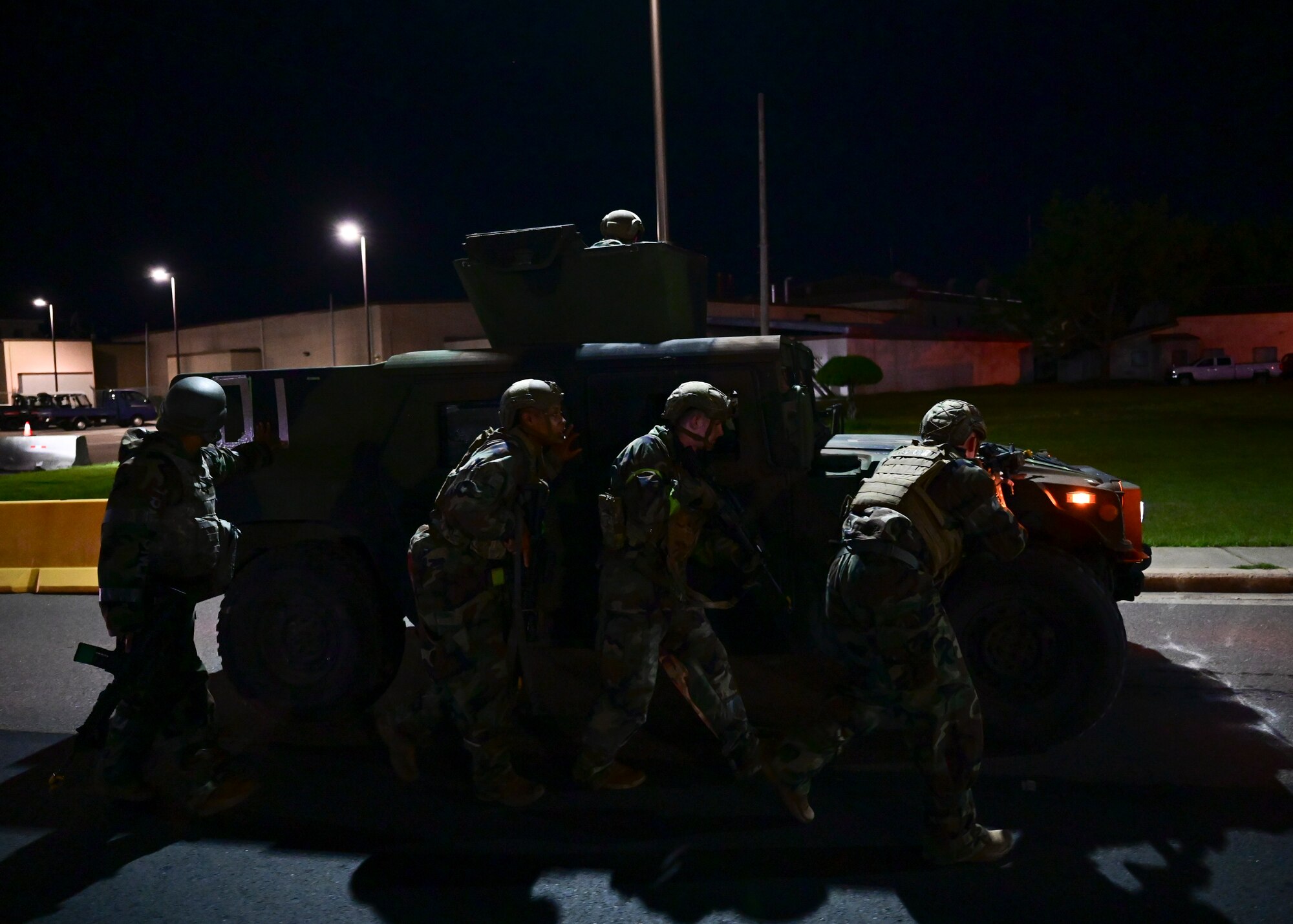 Defenders from the 8th Security Forces Squadron (SFS) maneuver while behind cover during a training event at Kunsan Air Base, Republic of Korea, Sept. 15, 2022. This training event pitted two teams of 8th SFS Airmen against each other in a simulated ground attack scenario. Training events provide opportunities for Wolf Pack Airmen to immerse in simulated real-world scenarios and ultimately remain mission ready. (U.S. Air Force photo by Staff Sgt. Isaiah J. Soliz)