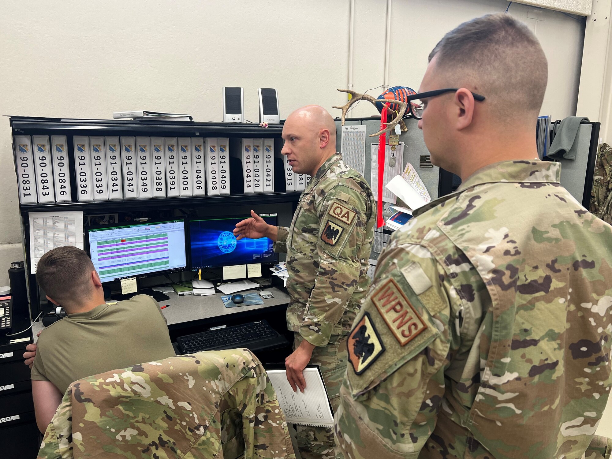 Production Assessment Team subject matter expert Senior Master Sgt. Dwayne Farr and Master Sgt. Nicholas Albert, both from the Air National Guard Readiness Center, discuss long-term maintenance forecasting processes with EGRESS technicians from the 148th Maintenance Squadron during an Air National Guard Production Assessment Team site visit at the 148th Fighter Wing September 12-15, 2022.