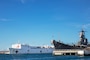 The Military Sealift Command hospital ship USNS Mercy (T-AH 19) passes the battleship USS Missouri Memorial while arriving at Joint Base Pearl Harbor-Hickam during Pacific Partnership 2022.