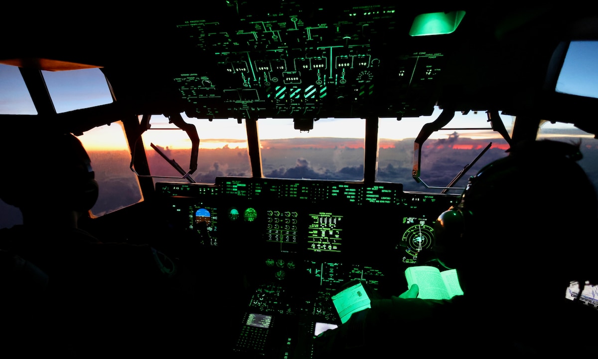 Pilots fly into tropical storm system, image showing sunset out of cockpit window.