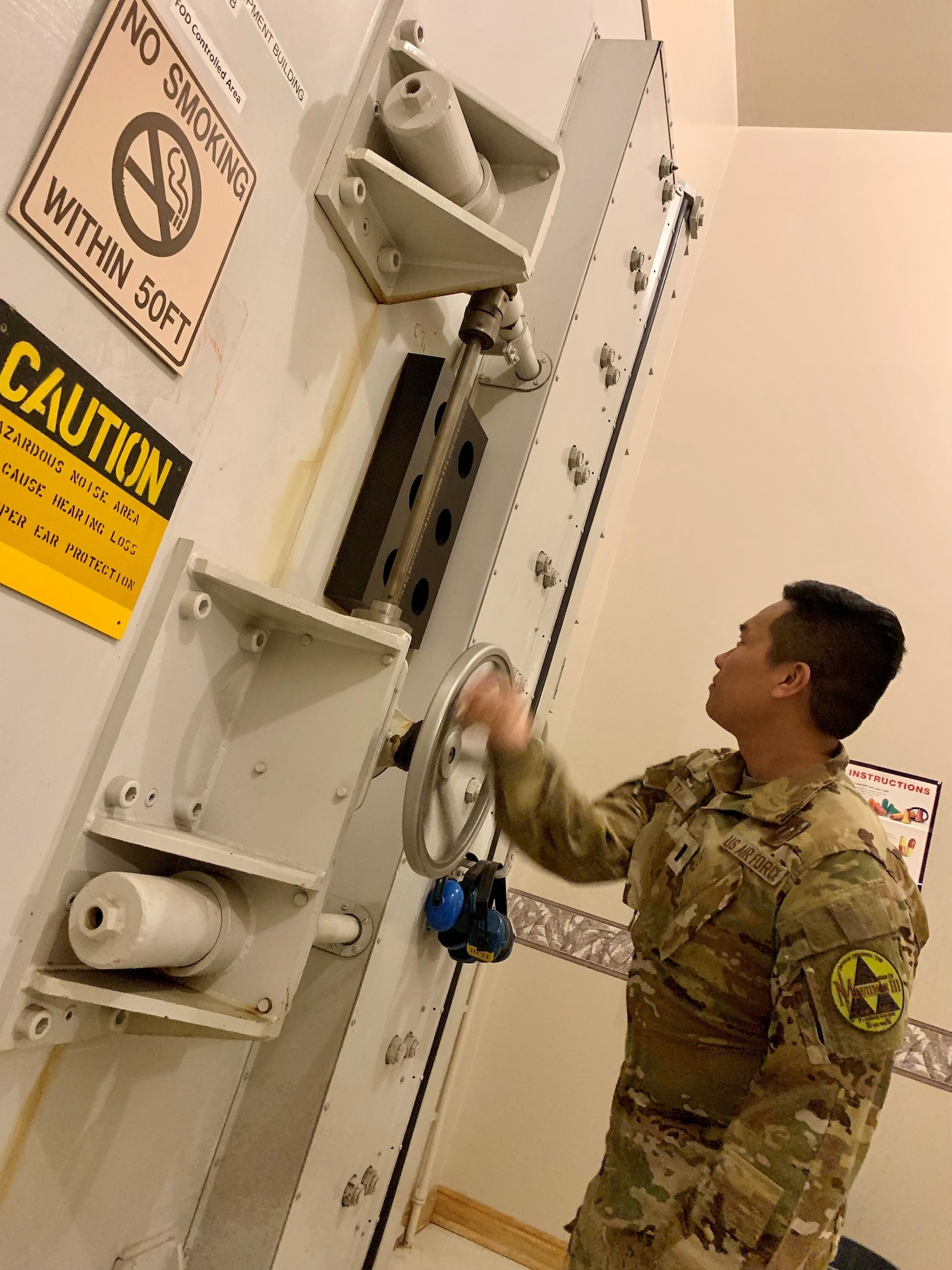 Air Force captain opens a door.