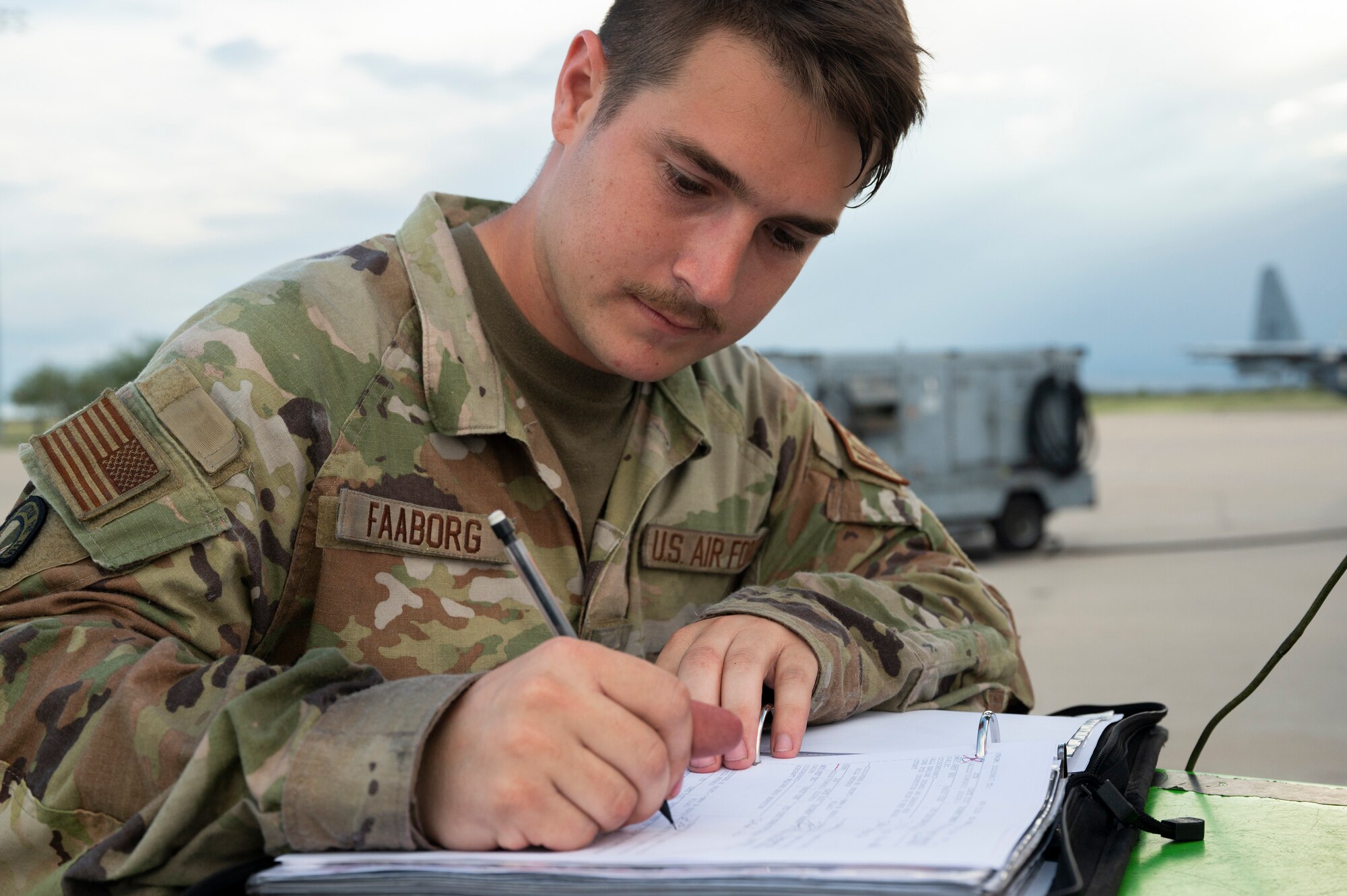 Photo of SSgt. Faaborg signing inspection checklist.