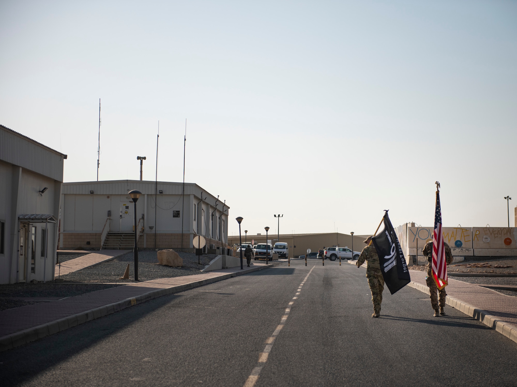 Staff Sgt. Aaron Watts, 386 Expeditionary Civil Engineer Squadron firefighter, marches along the side of a member of the 386 Expeditionary Security Forces Squadron at Ali Al Salem Air Base, Kuwaiti, 12 Sept. 2022 in remembrance of those lost on Sept. 11, 2001. Members from multiple branches of service and coalition teammates from throughout the world took part in the 24-hour march which started at 3:46 p.m. local time, 11 Sept 2022. (U.S. Air Force photo by Senior Master Sgt. David Salanitri)