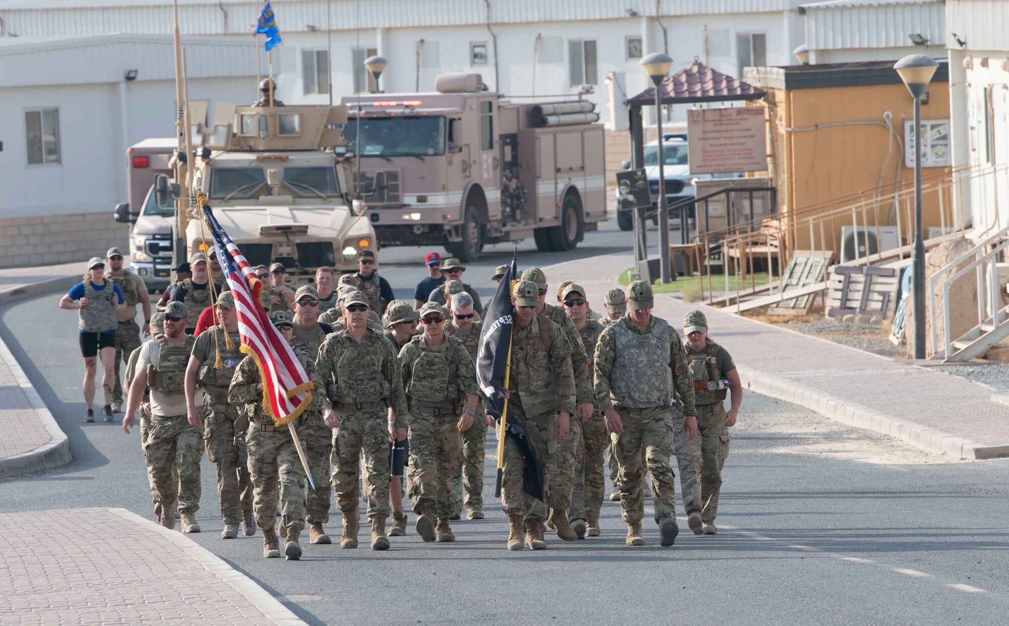 U.S. Airmen along with coalition partners from Ali Al Salem Air Base, Kuwait, finish the first lap of a 24-hour ruck led by Lt. Col. Tito Ruiz, 386th Expeditionary Security Forces Squadron commander, Lt. Col. Sylvester d’Agrella, 386th Expeditionary Civil Engineer Squadron commander, and Lt. Col John Stubbs, 386th Expeditionary Medical Squadron commander along with senior wing leadership, September 11, 2022. “Being here on 9/11 reminds me of why military service is important and reminds our adversaries of American resolve—if they hurt us we will work with our Allies and bring combat power upon them—that is deterrence…that is Coalition military power.” (U.S. Air Force photo by Staff Sgt. Ashley N. Mikaio)