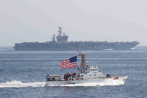 Coast Guard Cutter Adak of PATFORSWA provides escort for aircraft carrier USS Nimitz through the Strait of Hormuz. (U.S. Coast Guard)