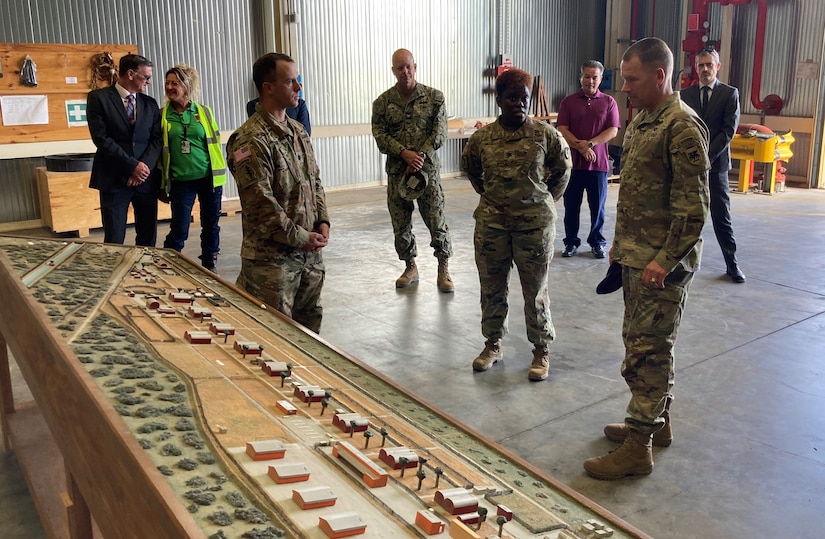 Army Lt. Col. Alexander Amato, the commander of Army Field Support Battalion-Africa, briefs the commanding general of Southern European Task Force – Africa and the commander of the 405th Army Field Support Brigade at Leghorn Army Deport in Livorno, Italy, Sept. 21. Amato said Maj. Gen. Todd Wasmund was impressed at the scope of the Army Prepositioned Stocks-2 maintenance and storage facilities and the battalion’s power projection capabilities, but marveled at the many years of skill inherent in the mostly Italian local national workforce at the APS-2 site. (photo by Sgt. 1st Class Guido Fermin)