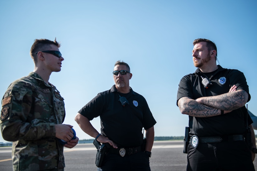 U.S. Air Force Staff Sgt. Christian Magliocca, 15th Airlift Squadron air and land loadmaster, and personnel from the North Charleston Police Department talk about the nuances of the joint training exercise at Joint Base Charleston, South Carolina, Sept.16, 2022. The NCPD conducted various training practices including tight proximity parking and low-speed maneuvering. (U.S. Air Force photo by Airman 1st Class Christian Silvera)