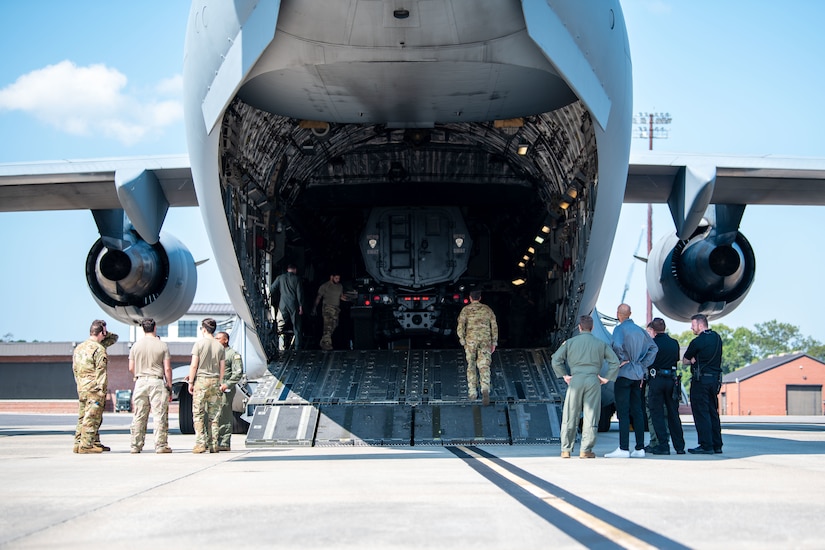 U.S. Air Force Airmen from the 15th and 16th Airlift Squadrons and personnel from the North Charleston Police Department, observe as loadmasters load a police Mine Resistant Ambush Protected Vehicle, or MRAP, onto a C-17 Globemaster III for a training exercise at Joint Base Charleston, South Carolina, Sept.16, 2022. The exercise prepared loadmasters to load larger vehicles onto a C-17 Globemaster III aircraft - a potential wartime scenario. (U.S. Air Force photo by Airman 1st Class Christian Silvera)