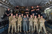 U.S. Air Force Airmen from the 15th and 16th Airlift Squadrons and personnel from the North Charleston Police Department pose for a group photo during a joint training exercise at Joint Base Charleston, South Carolina, Sept.16, 2022. The exercise prepared loadmasters to load larger vehicles onto a C-17 Globemaster III aircraft - a potential wartime scenario. (U.S. Air Force photo by Airman 1st Class Christian Silvera)