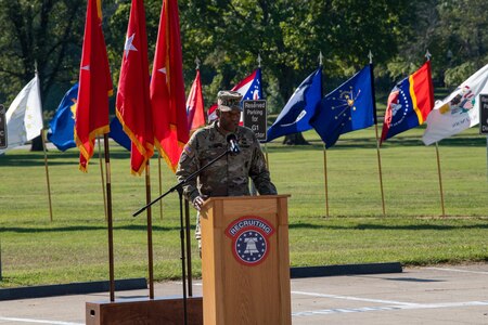 man in u.s. army uniform gives a speech at a podium