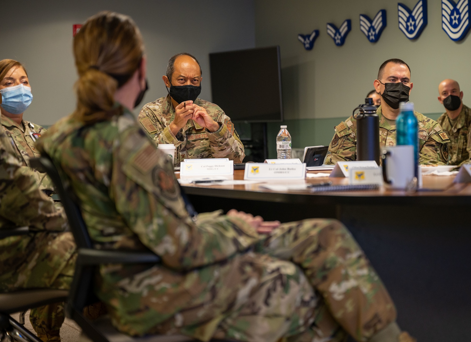 Col. Rudolph Cachuela, Air Mobility Command surgeon general, center, listens to a briefing during his visit to Dover Air Force Base, Delaware, Sept. 20, 2022. Cachuela toured the 436th Medical Group, Air Force Mortuary Affairs Operations and Bedrock Innovation Lab. (U.S. Air Force photo by Senior Airman Cydney Lee)