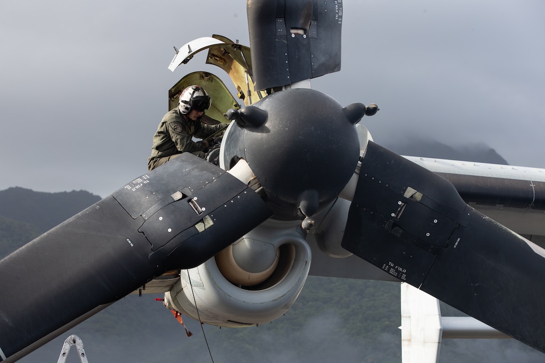 A U.S. Marine with Marine Medium Tiltrotor Squadron 268 Reinforced, Aviation Combat Element, Marine Rotational Force-Darwin 22, conducts pre-flight checks on an MV-22 Osprey during a Transpacific flight in American Samoa, Sept. 16, 2022. TRANSPAC was a long-range tactical redeployment from Darwin to Hawaii with stops in Fiji, American Samoa, and Kiribati.