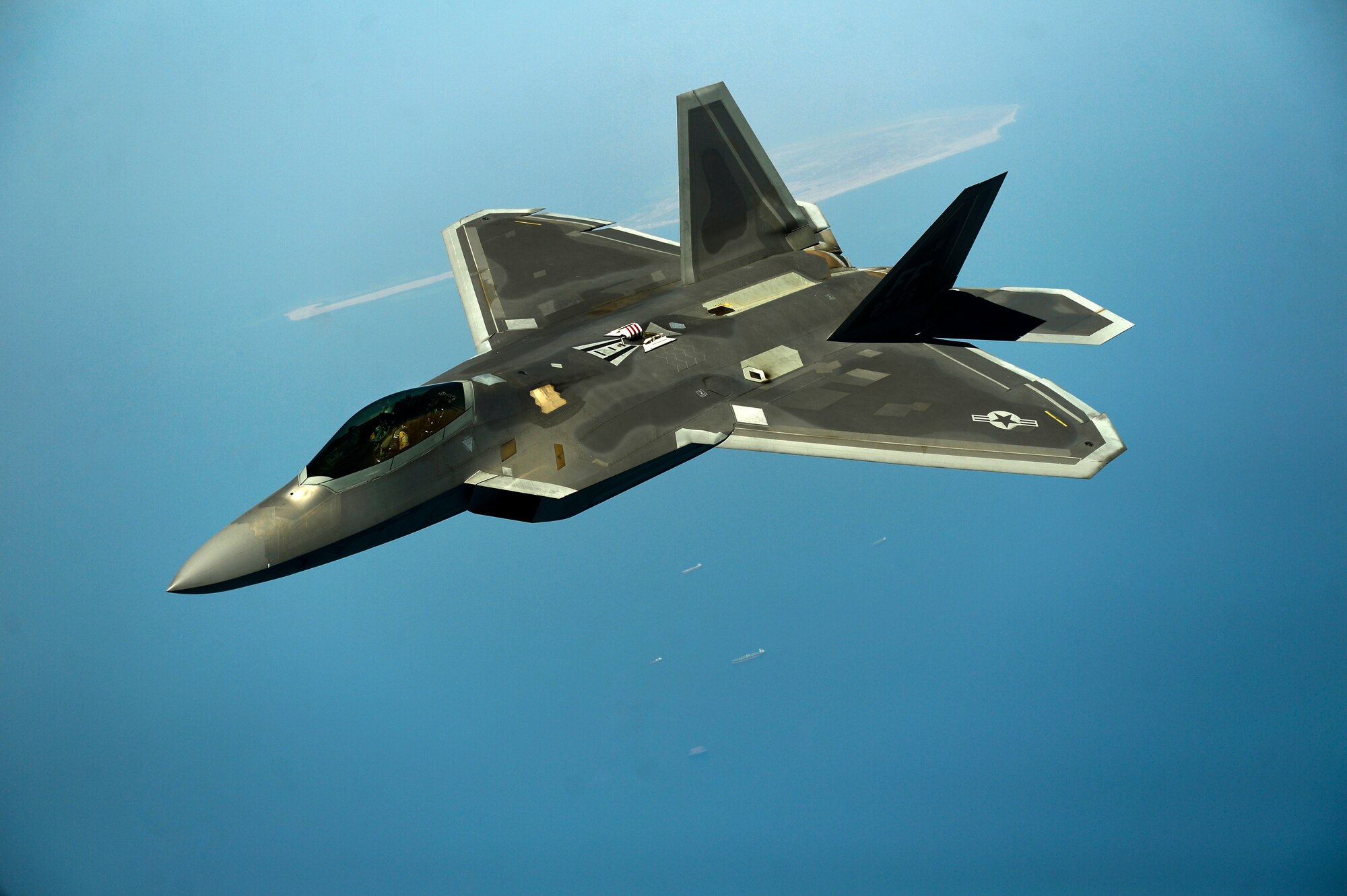 A U.S. Air Force F-22 maneuvers after being in-air refueled April 25, 2014, over the U.S. Central Command Area of responsibility by a KC-135 Stratotanker and aircrew from the 340th Expeditionary Air Refueling Squadron, Al Udeid Air Base, Qatar. The F-22 Raptor is an advanced capability aircraft that can be provided to the Combined Forces Air Component Commander within the region to enhance missions supporting stability and security. (U.S. Air Force photo by Staff Sgt. Vernon Young Jr./Released)