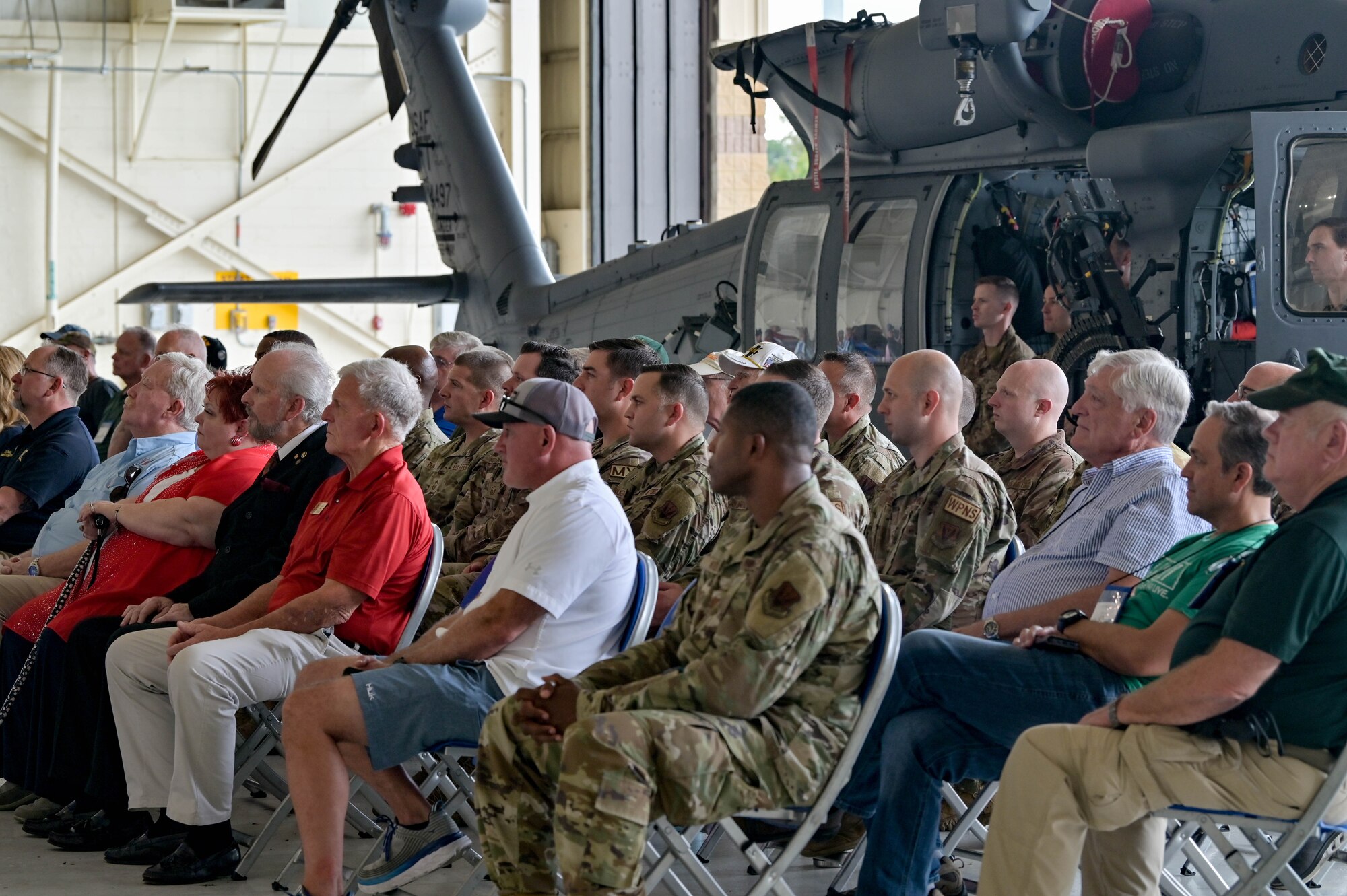 Service members, members of the Air Rescue Association, prior rescue community members and their families listen to the HH-60W Jolly Green II Initial Operational Capability ceremony speeches, Sept. 9, 2022      at Moody Air Force Base, Georgia. The ceremony displayed the platform’s operational capabilities and signifies that the HH-60W Jolly Green II has met the criteria for IOC and awaits declaration. (U.S. Air Force photo by Senior Airman Rebeckah Medeiros)
