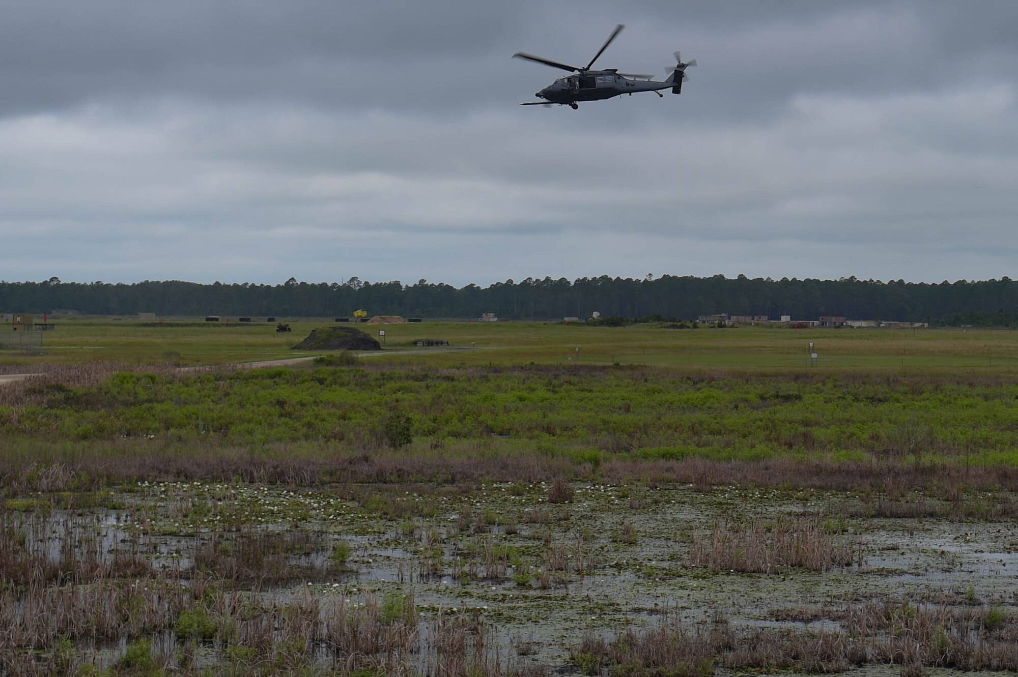 U.S. Air Force Airmen assigned to the 41st Rescue Squadron conduct a combat search and rescue demonstration over Grand Bay Bombing and Gunnery Range at Moody Air Force Base, Georgia, Sept. 9, 2022. The demonstration accompanied by a ceremony signified that the HH-60W Jolly Green II has met the criteria for initial operational capability and postured for declaration. (U.S. Air Force photo by Airman 1st Class Briana Beavers)